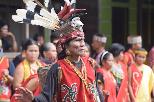 Vibrant celebration of Dayak culture with traditional costumes and rituals in Kalimantan Barat, Indonesia.